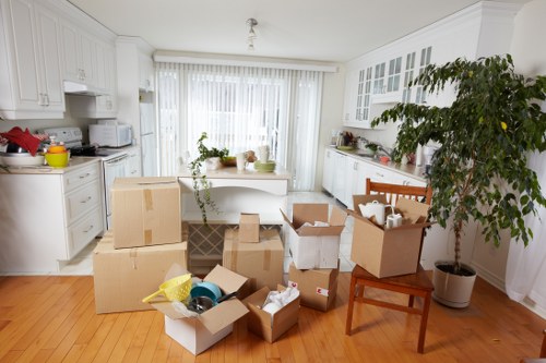 Packed moving boxes and wrapped furniture ready for transport