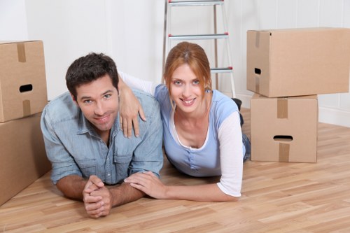 Local movers carrying furniture through a residential property in Debeauvoirtown